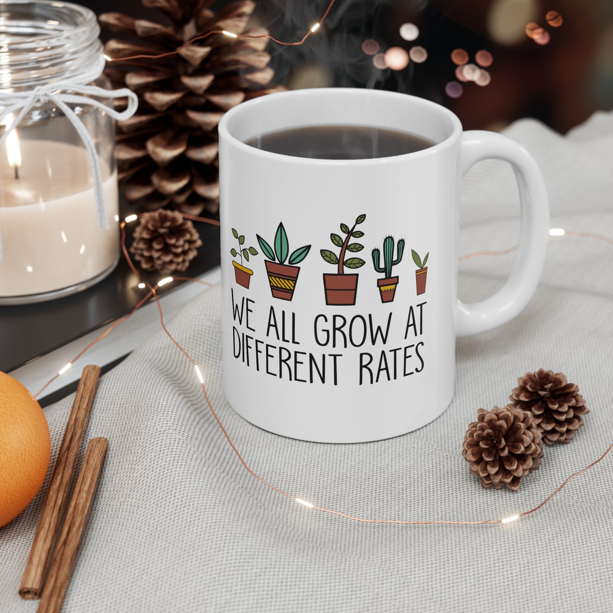 WE ALL GROW AT DIFFERENT RATES MUG